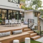 A modern multi-level wooden deck with built-in seating, dining area, and contemporary house architecture.